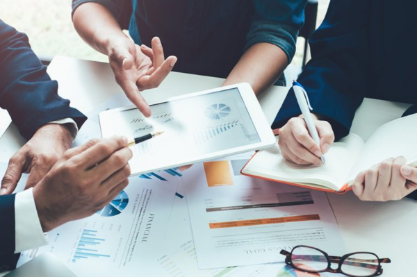 Professional guiding a client through Chapter 7 bankruptcy paperwork in a supportive office environment.